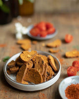 Biscuiterie de Provence Croquets mit Tomaten & Piment d’Espelette in Schale angerichtet, mit frischen Tomaten und Gewürzen dekoriert