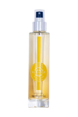 Durance Körperspray Sensual Monoi in transparenter Flasche mit Pumpspender und gelbem Farbverlauf, freigestellt
