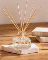 Durance Raumduft Diffuser aus Glas mit naturfarbenen Duftstäbchen auf Holztisch dekorativ inszeniert